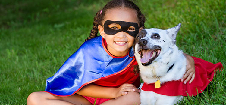 Happy girl and her dog dressed for Halloween Happy girl and her dog dressed for Halloween