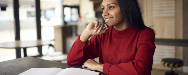 Happy woman devising time-change checklist Happy woman devising time-change checklist