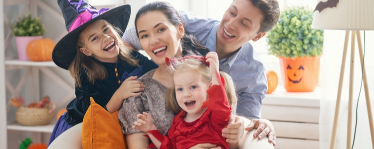 Happy family practicing Halloween fire safety tips Happy family practicing Halloween fire safety tips